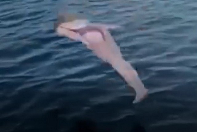 Девушка прыгает в воду опасным способом с большой высоты